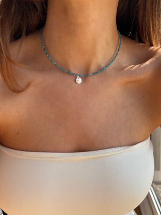 everyday layering beachy necklace with blue gemstones and a sand dollar pendant