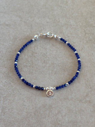 navy blue beaded gemstone bracelet with custom engraved initial 
